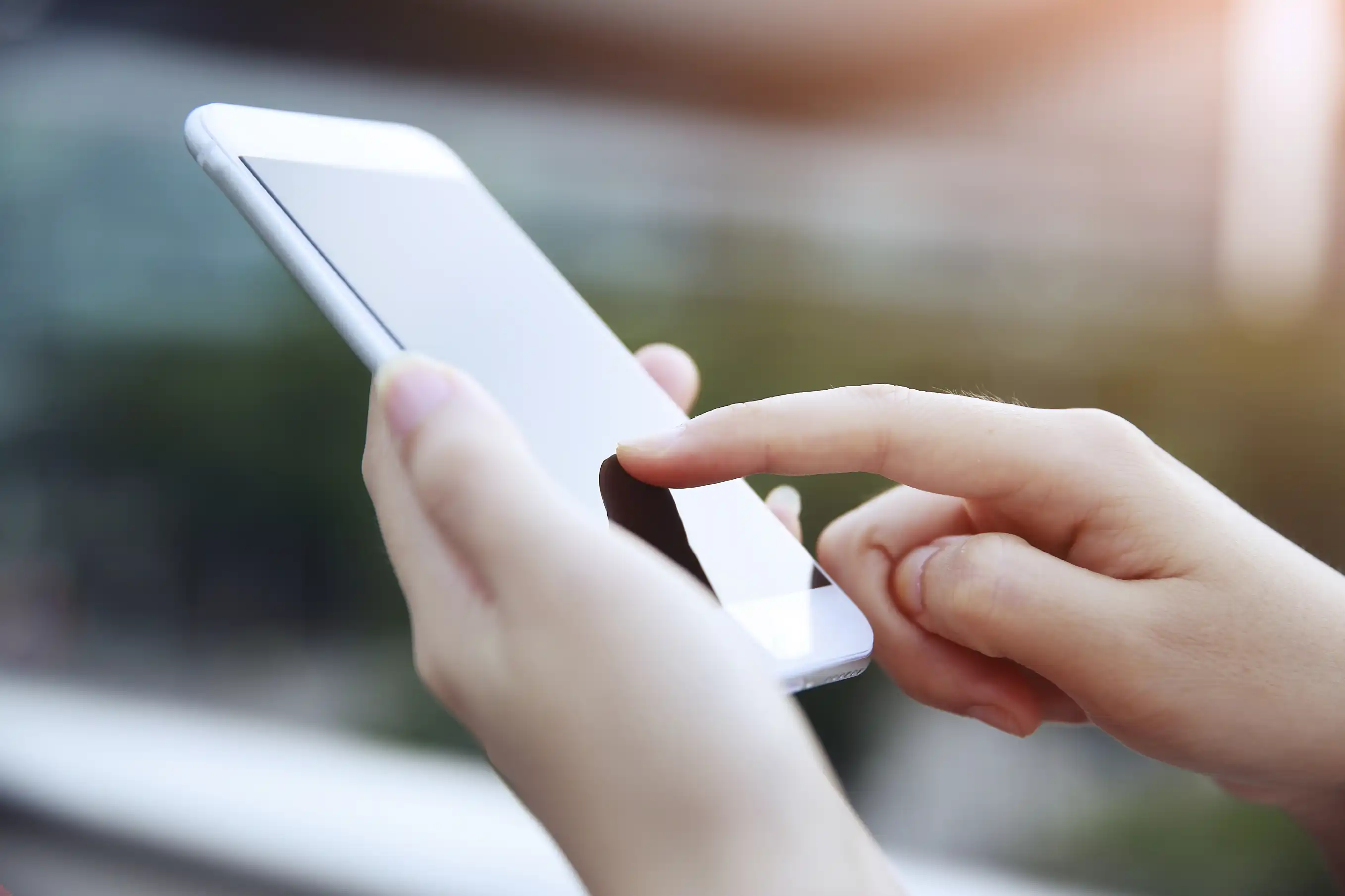 close up of hands touching phone screen.